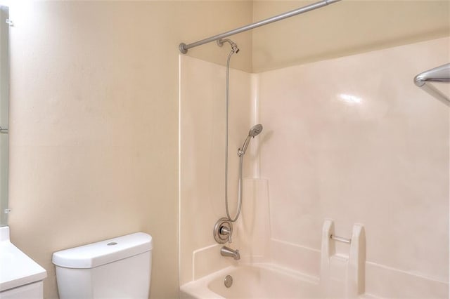 bathroom with bathing tub / shower combination, vanity, and toilet