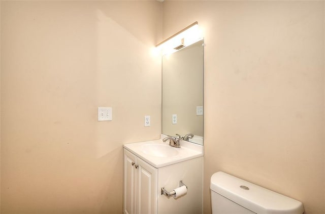 half bath with vanity and toilet