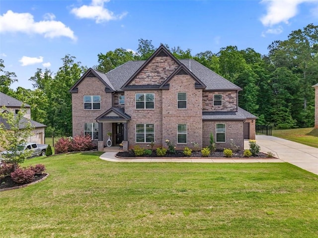 craftsman-style home featuring brick siding, driveway, and a front yard