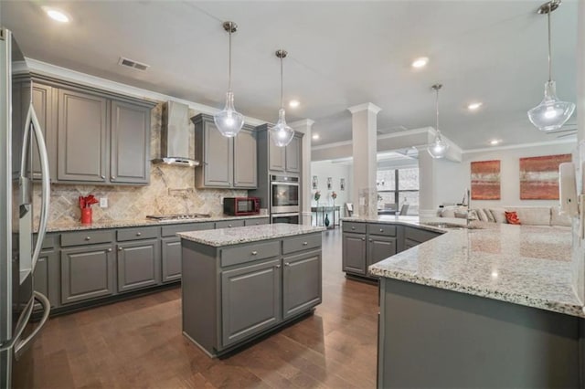 kitchen featuring gray cabinets, a large island, visible vents, crown molding, and wall chimney exhaust hood