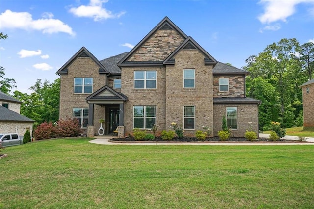 craftsman house featuring brick siding and a front lawn