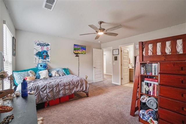 carpeted bedroom with baseboards, a ceiling fan, and visible vents