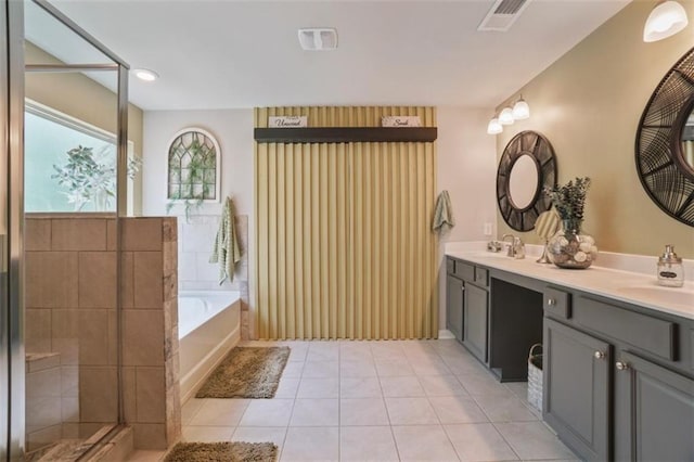 bathroom with visible vents, a sink, a bath, and tile patterned flooring