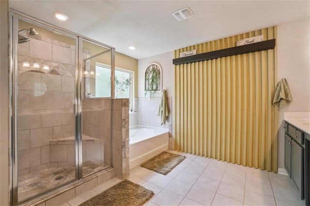bathroom featuring a bath, visible vents, a stall shower, vanity, and tile patterned floors