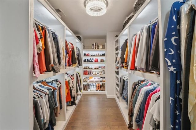 walk in closet featuring visible vents and wood finished floors