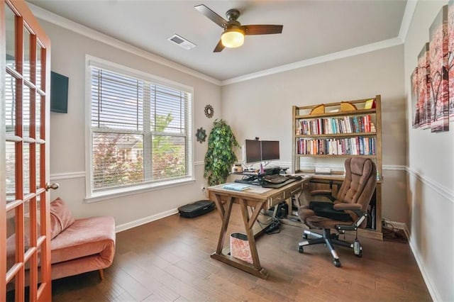 home office featuring visible vents, a ceiling fan, crown molding, and wood finished floors