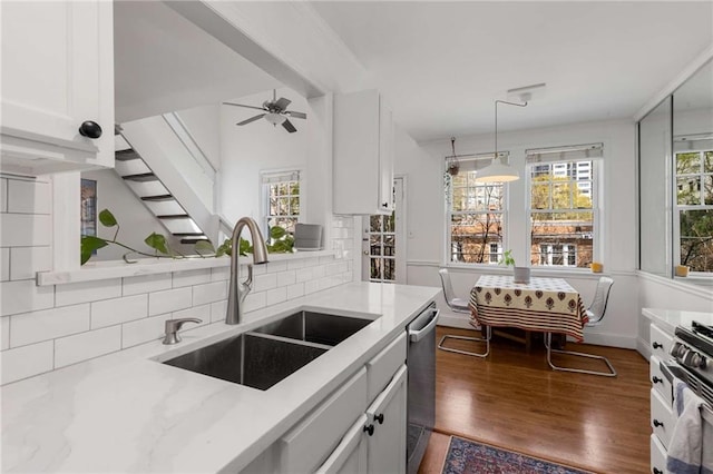 1078 Piedmont Ave NE Unit 203, Atlanta, GA 30309 - kitchen with a sink, dishwasher, gas range, white cabinetry, and decorative backsplash