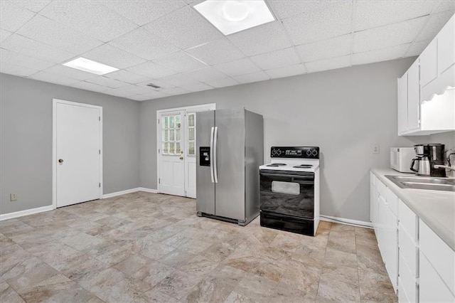 5891 Ranger Ct, Peachtree Corners, GA 30092 - kitchen featuring stainless steel fridge with ice dispenser, range with electric stovetop, a sink, a drop ceiling, and white cabinetry