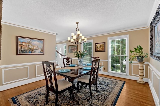 5891 Ranger Ct, Peachtree Corners, GA 30092 - dining area with a textured ceiling, a chandelier, crown molding, and light wood-style flooring