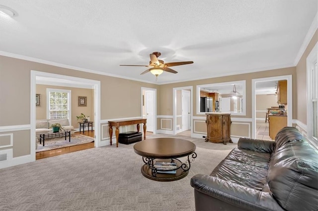 5891 Ranger Ct, Peachtree Corners, GA 30092 - living room with a ceiling fan, ornamental molding, light carpet, a textured ceiling, and a decorative wall