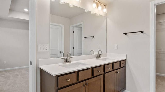 1570 Halbrook Pl, Marietta, GA 30008 - bathroom with a sink, a walk in closet, and baseboards