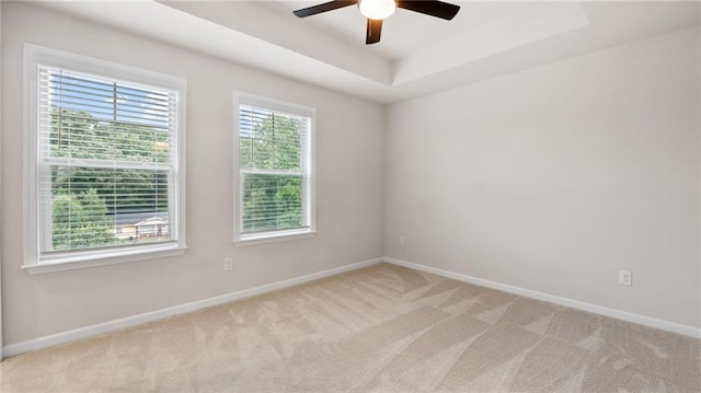 1570 Halbrook Pl, Marietta, GA 30008 - spare room featuring light colored carpet, a raised ceiling, baseboards, and a ceiling fan