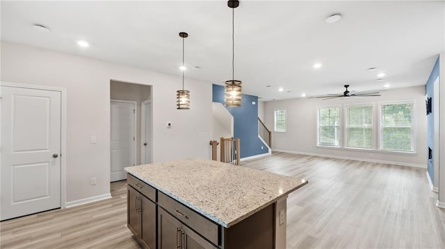 1570 Halbrook Pl, Marietta, GA 30008 - kitchen featuring a ceiling fan, a center island, decorative light fixtures, baseboards, and light wood-style floors