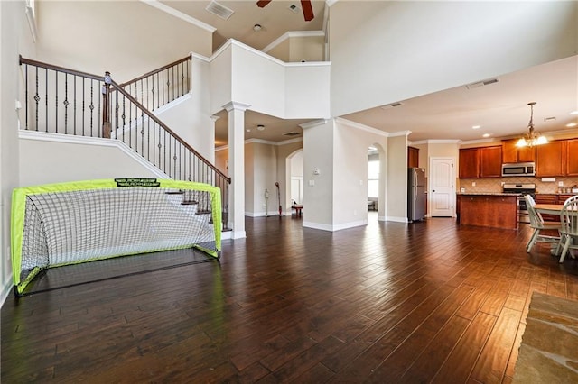 living room featuring baseboards, ceiling fan, visible vents, and dark wood-type flooring