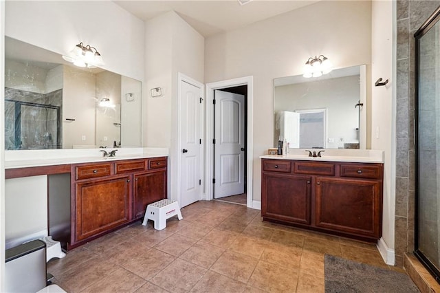 bathroom featuring a sink, a stall shower, two vanities, and tile patterned floors