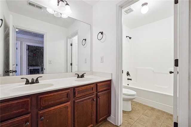 bathroom with toilet, a sink, and visible vents