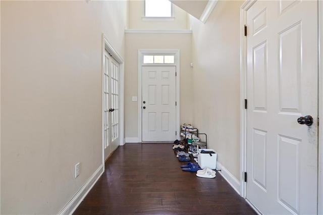 foyer entrance featuring dark wood-type flooring and baseboards