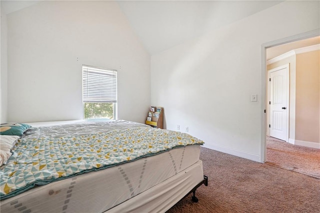 carpeted bedroom with lofted ceiling and baseboards