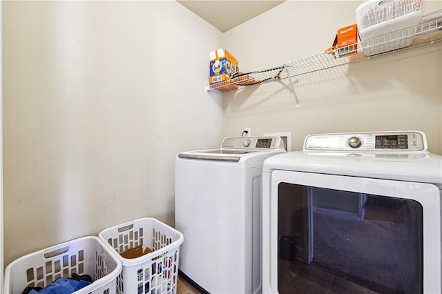 laundry area with laundry area and washer and clothes dryer