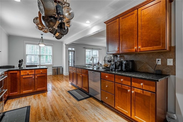 kitchen featuring sink, stainless steel dishwasher, dark stone countertops, ornamental molding, and tasteful backsplash