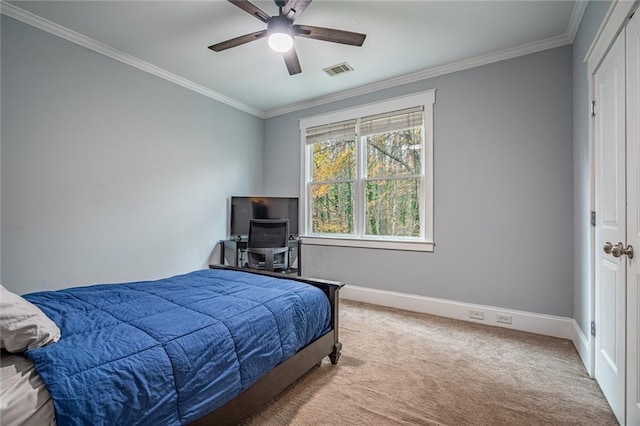 bedroom with carpet, ceiling fan, and crown molding