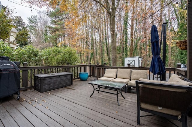 wooden terrace featuring outdoor lounge area, area for grilling, and a shed