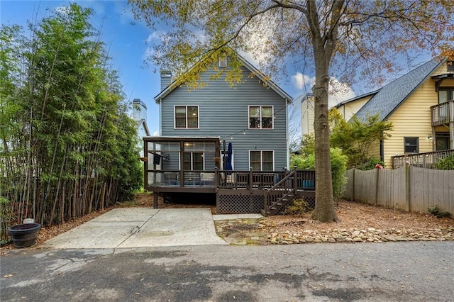 back of property featuring a wooden deck