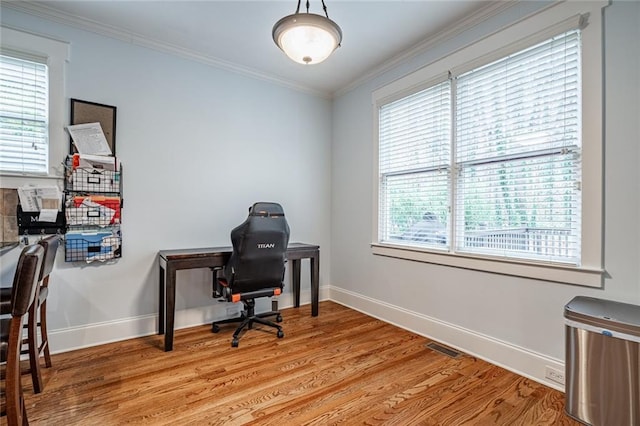 office with plenty of natural light, light wood-type flooring, and ornamental molding