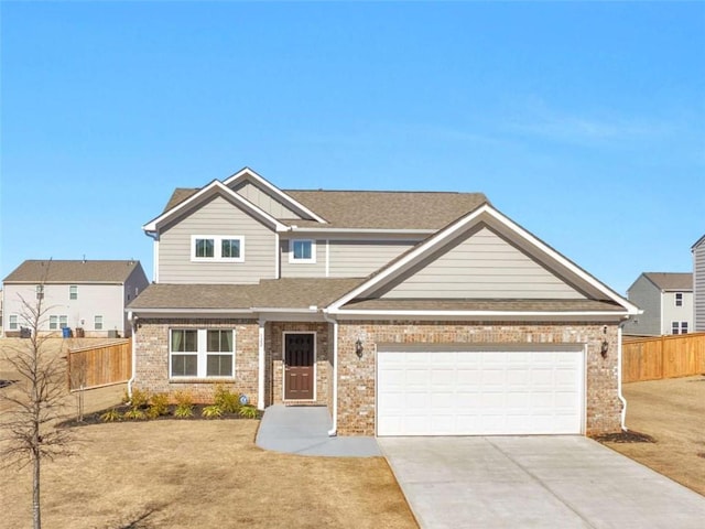 craftsman-style house with concrete driveway, brick siding, and fence