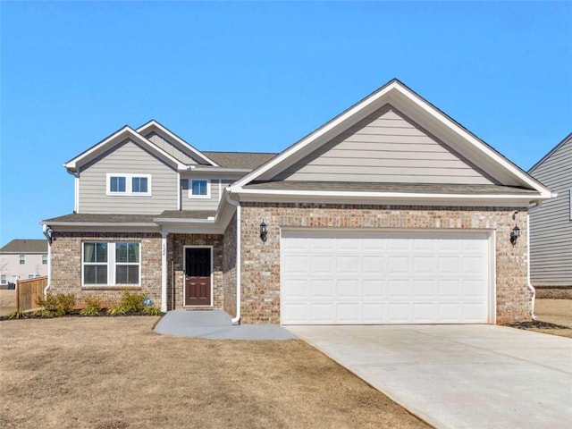 craftsman house with driveway, brick siding, and an attached garage