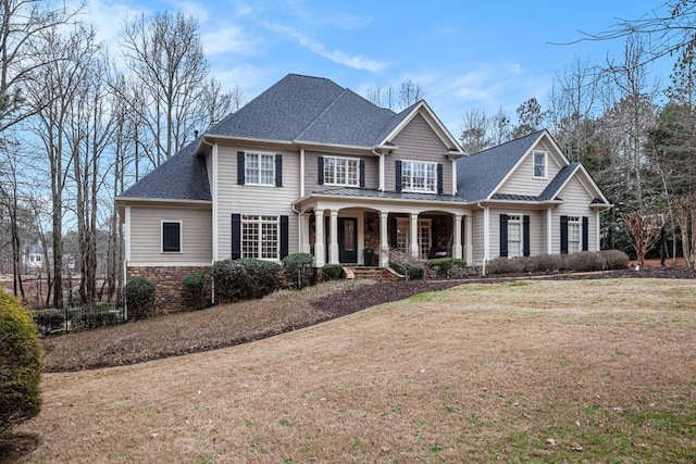 view of front of house with a porch and a front lawn