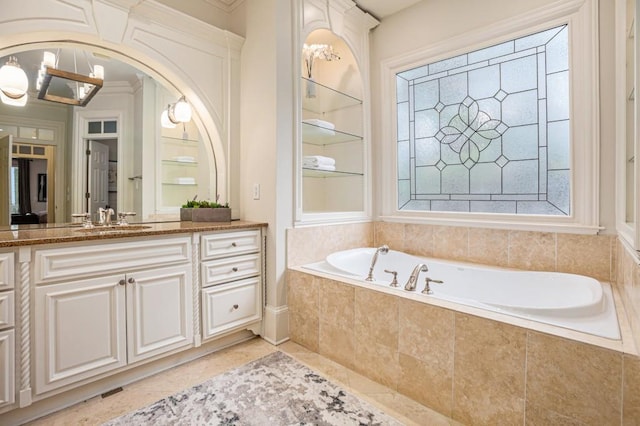 bathroom with vanity, tiled bath, tile patterned flooring, and a notable chandelier