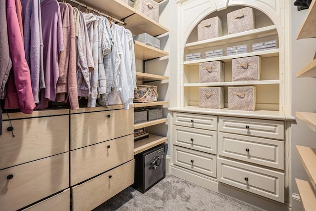 walk in closet featuring light carpet