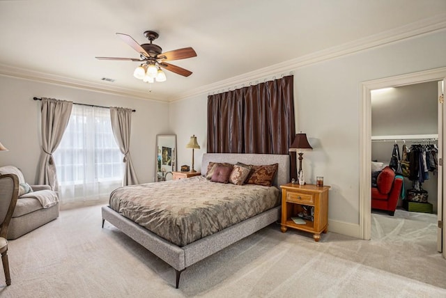 bedroom with ornamental molding, a walk in closet, light carpet, and a closet