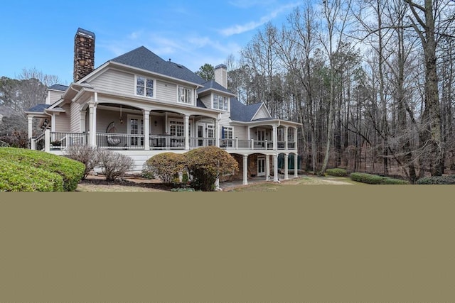 back of property featuring covered porch