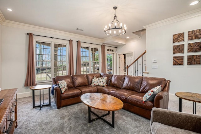 carpeted living room featuring plenty of natural light, ornamental molding, and a chandelier