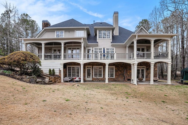 back of house with a yard and a patio area