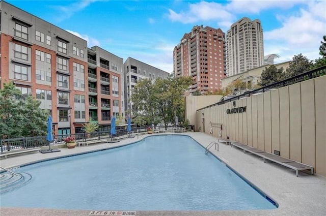 view of pool featuring fence