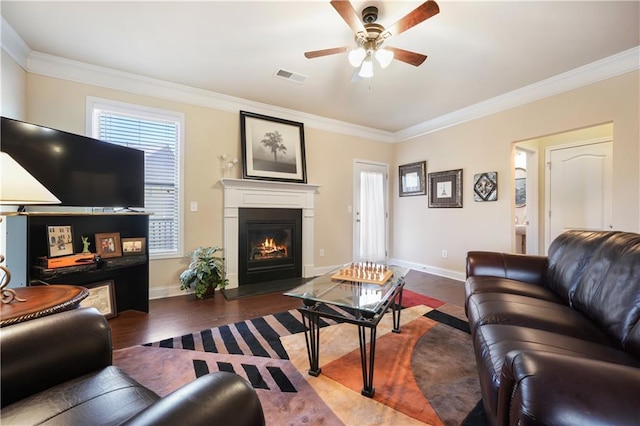 living room with ceiling fan, crown molding, and dark hardwood / wood-style floors