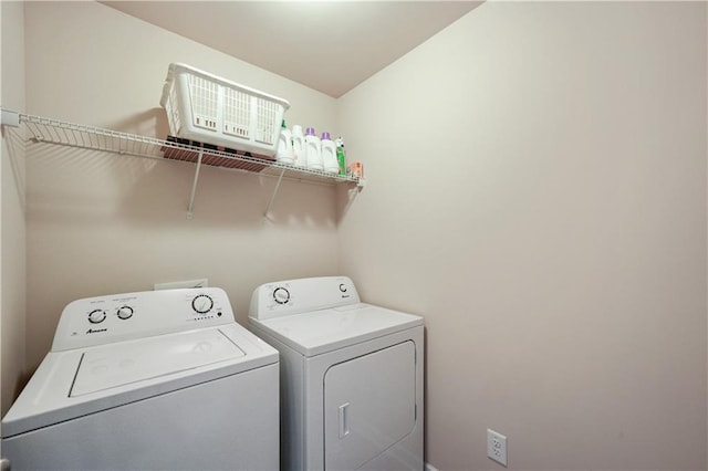 clothes washing area with washer and dryer