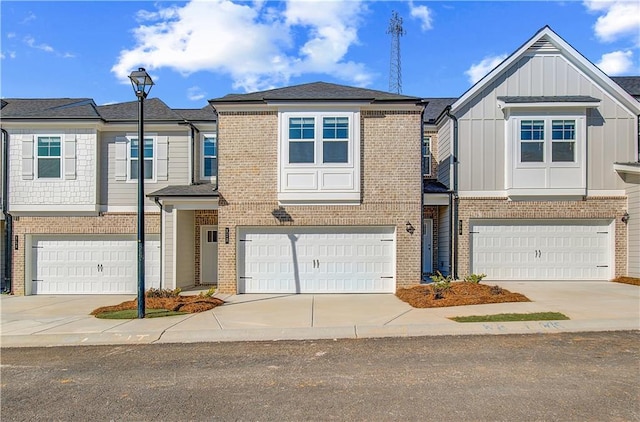 townhome / multi-family property featuring concrete driveway, brick siding, and an attached garage