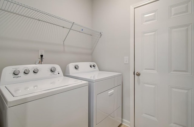 clothes washing area featuring separate washer and dryer