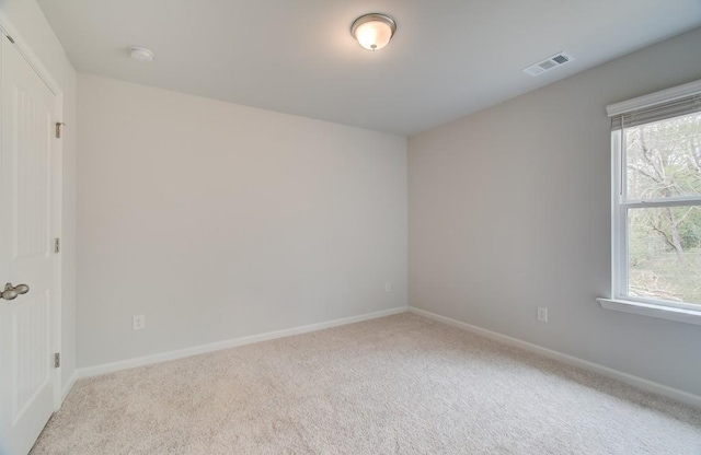 carpeted spare room with plenty of natural light