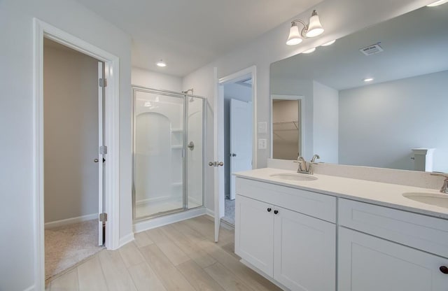 bathroom featuring vanity, a shower with door, and hardwood / wood-style floors