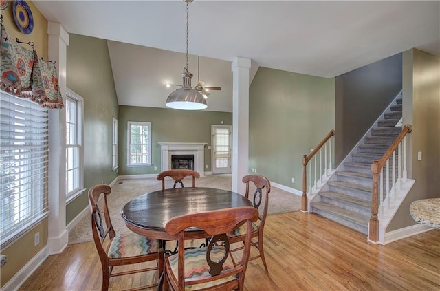 27 Planters Dr NW, Cartersville, GA 30120 - dining area with a fireplace, light wood finished floors, stairs, baseboards, and a high ceiling