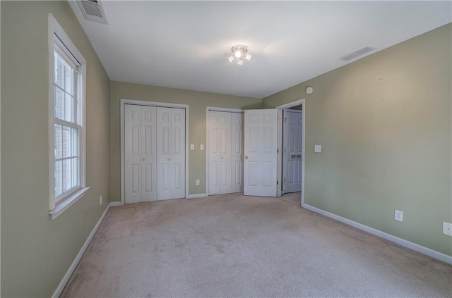 27 Planters Dr NW, Cartersville, GA 30120 - unfurnished bedroom with baseboards, two closets, and light carpet