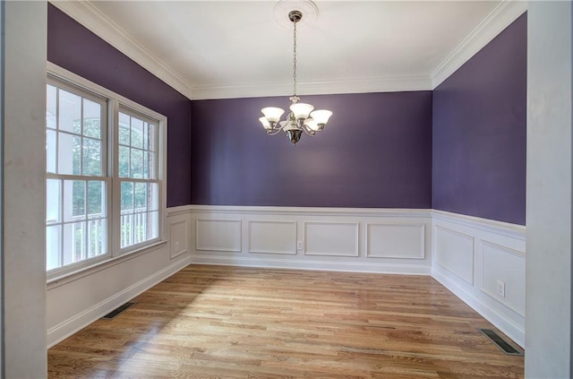 27 Planters Dr NW, Cartersville, GA 30120 - unfurnished room featuring healthy amount of natural light, a chandelier, wainscoting, light wood-type flooring, and crown molding