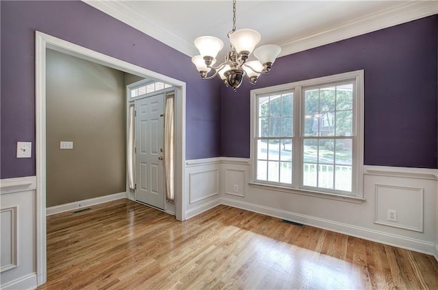 27 Planters Dr NW, Cartersville, GA 30120 - unfurnished dining area featuring a chandelier, a wainscoted wall, crown molding, and light wood-style floors