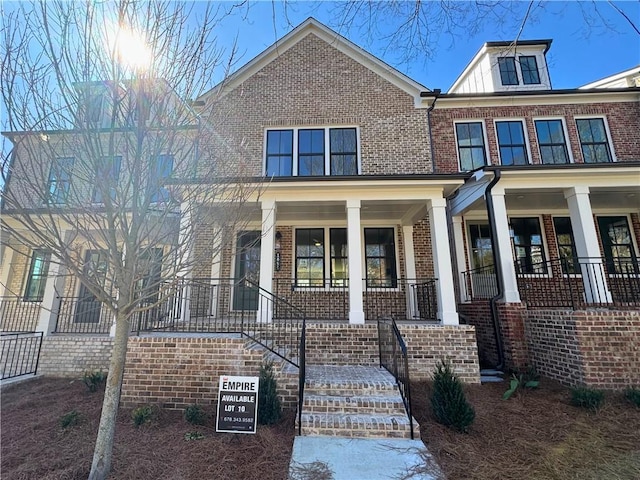 view of front facade with a porch and brick siding