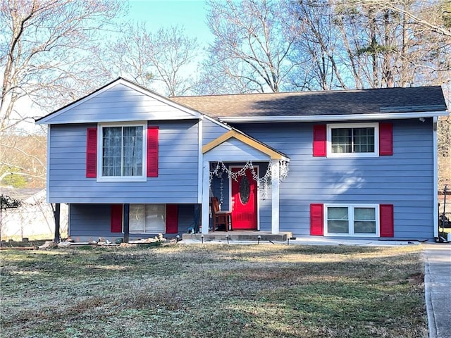 raised ranch featuring a front lawn